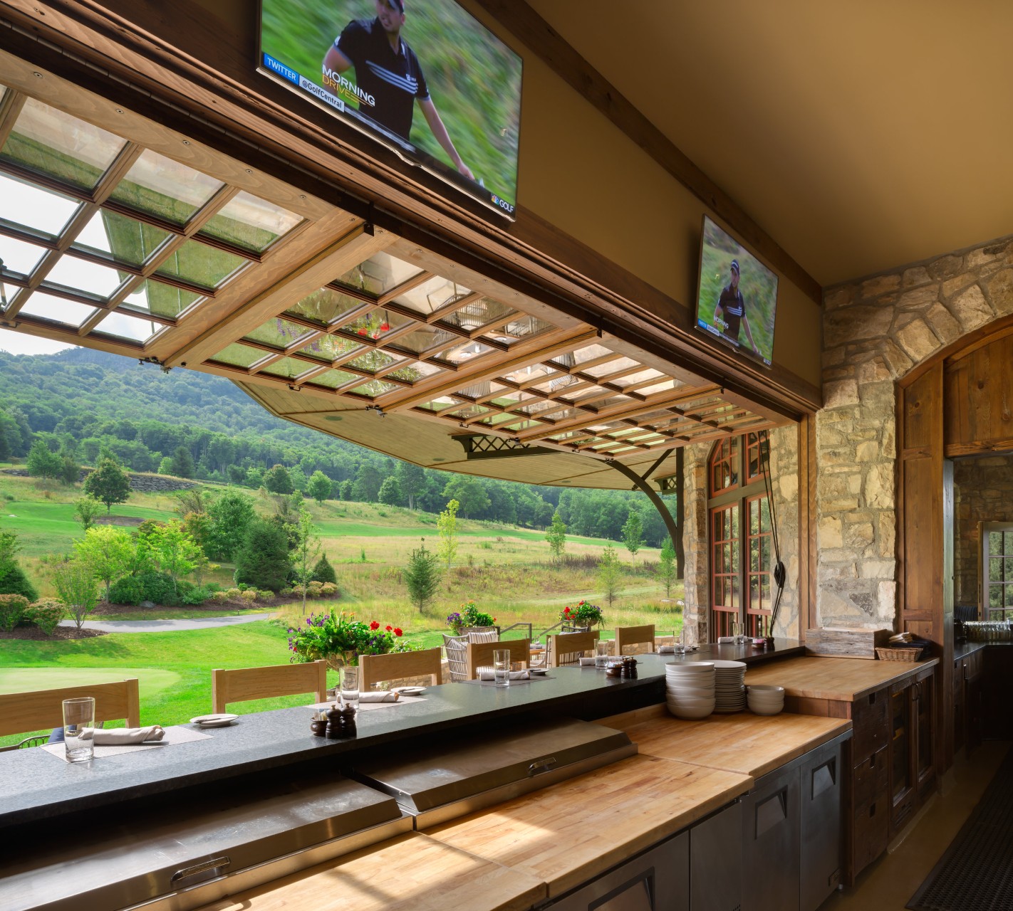 Diamond Creek club bar with folding windows overlooking golf course, custom cabinetry